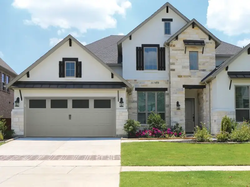 Modern residential home with a stylish garage door, showcasing expert garage door installation by Overhead Door Company of The Antelope Valley™ in Lancaster, CA.