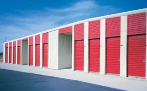 Row of red rolling service doors on a commercial building, showcasing durability and design for efficient access in business environments.